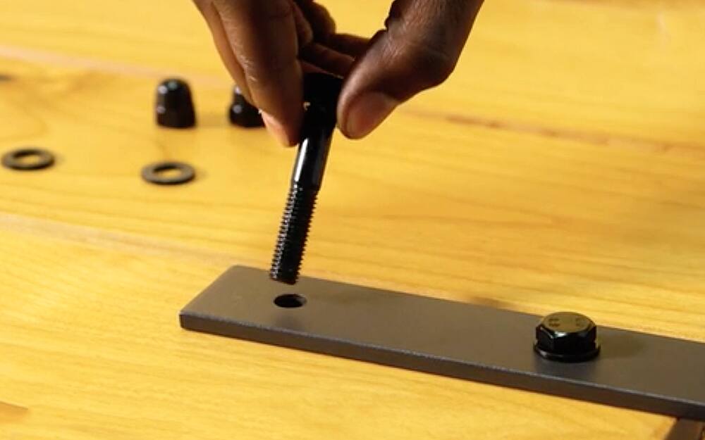 A person attaches hardware to the door. A person attaches hardware to the door.