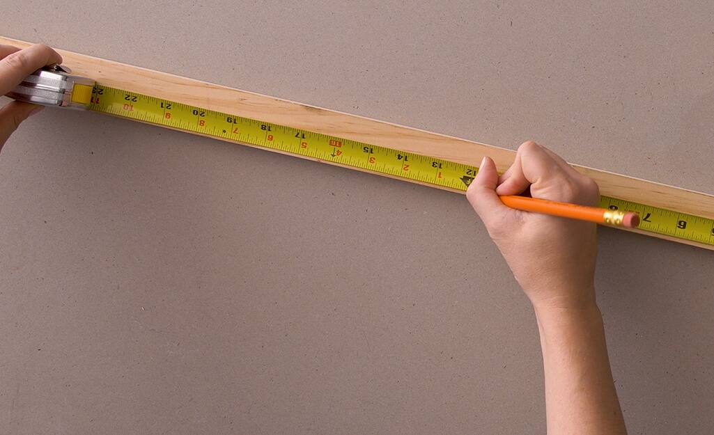 A tape measure is used to measure wood. A tape measure is used to measure wood.