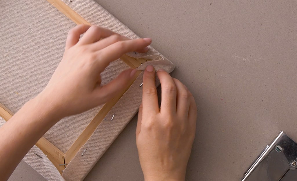 A canvas cloth is stapled to the wood frame. A canvas cloth is stapled to the wood frame.