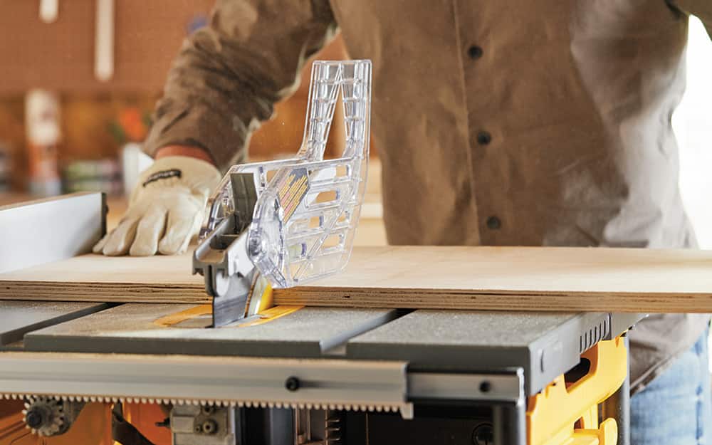Man cutting support boards for the closet organizer. Man cutting support boards for the closet organizer.