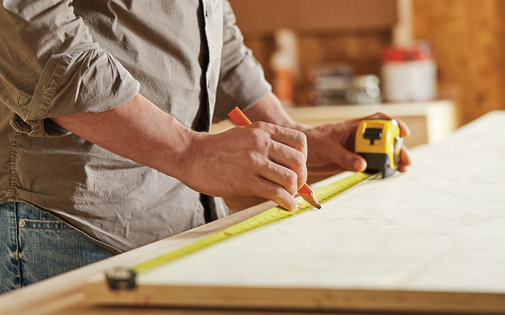 Man measuring wood for the closet organizer. Man measuring wood for the closet organizer.