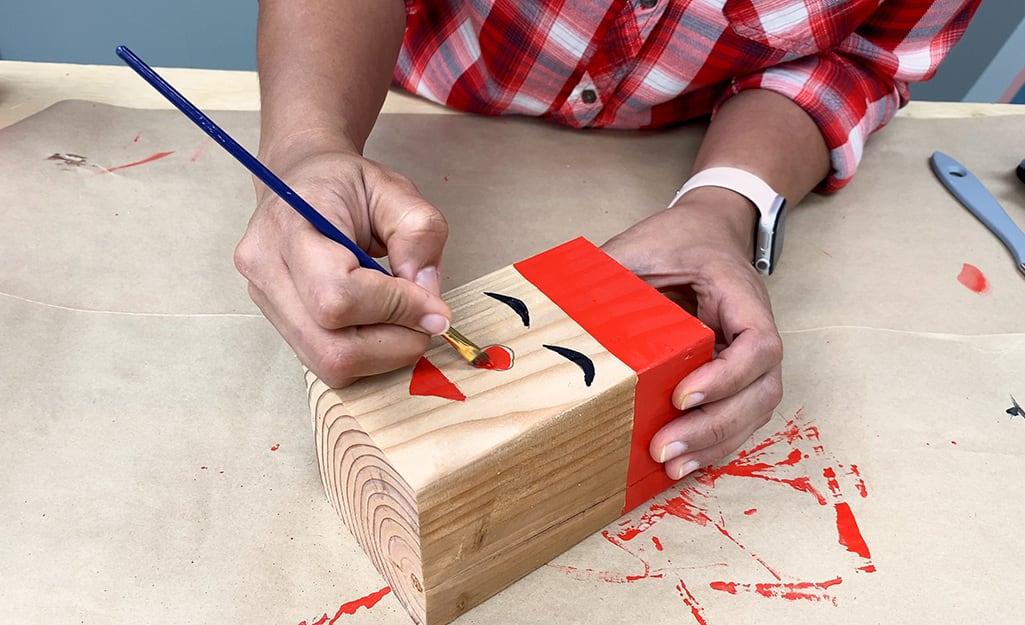 The top block is painted to resemble Santa's face and hat. The top block is painted to resemble Santa's face and hat.