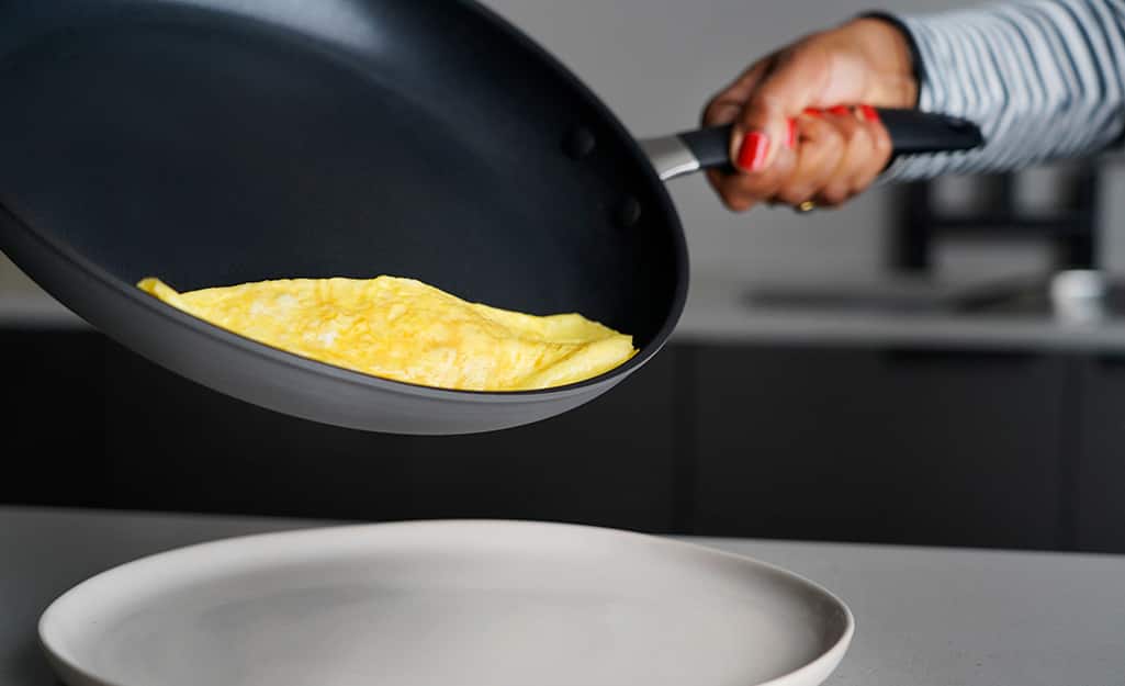 An egg is cooked in a non-stick frying pan. An egg is cooked in a non-stick frying pan.