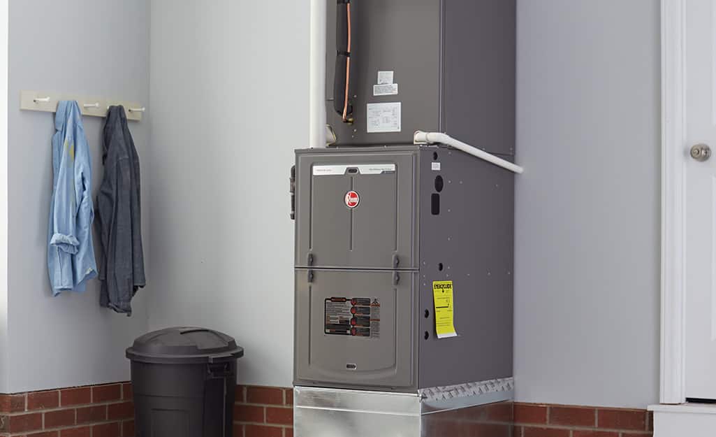 A furnace in a utility space of a home. A furnace in a utility space of a home.