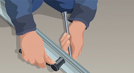 A person uses a socket wrench to assemble a garage door opener carriage tube. A person uses a socket wrench to assemble a garage door opener carriage tube.