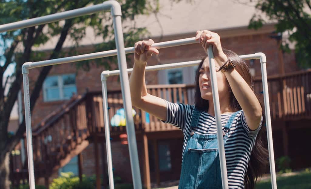 A person connects the top bars of a DIY kids sprinkler. A person connects the top bars of a DIY kids sprinkler.