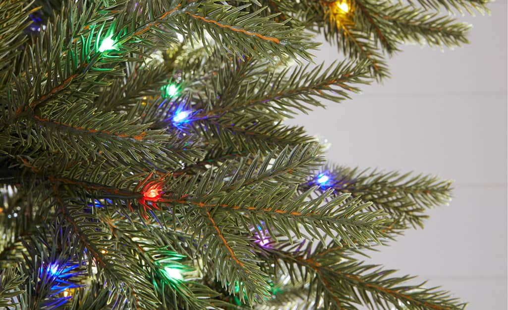 A close up of a pre-lit artificial Christmas tree. A close up of a pre-lit artificial Christmas tree.