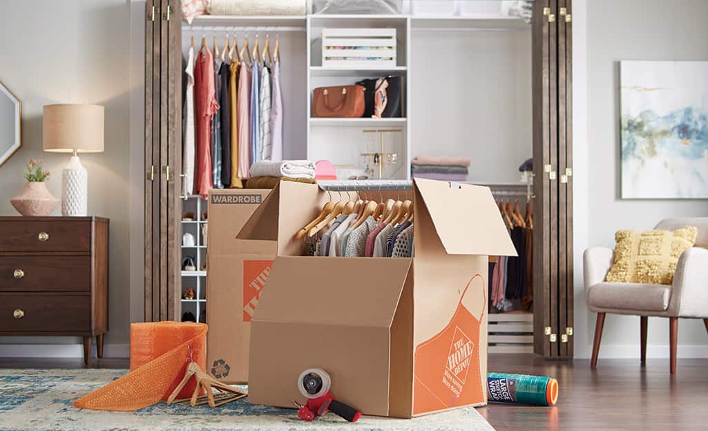The Home Depot cardboard wardrobe boxes being packed in a bedroom. The Home Depot cardboard wardrobe boxes being packed in a bedroom.