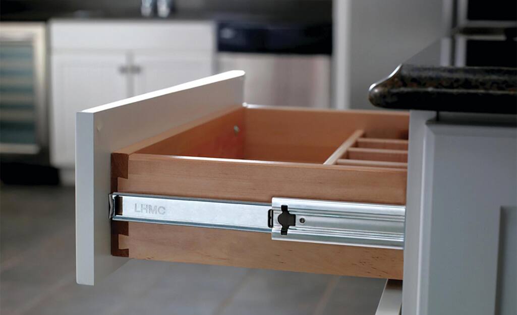 An open kitchen drawer installed with soft-close slides.