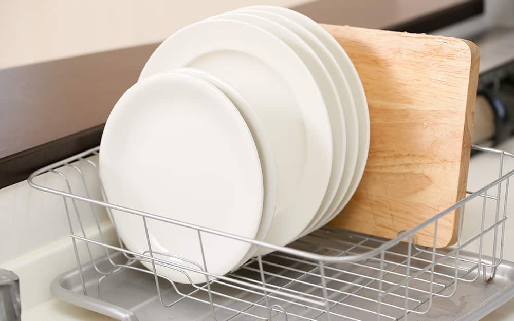 A cutting board drying in a dish rack. A cutting board drying in a dish rack.