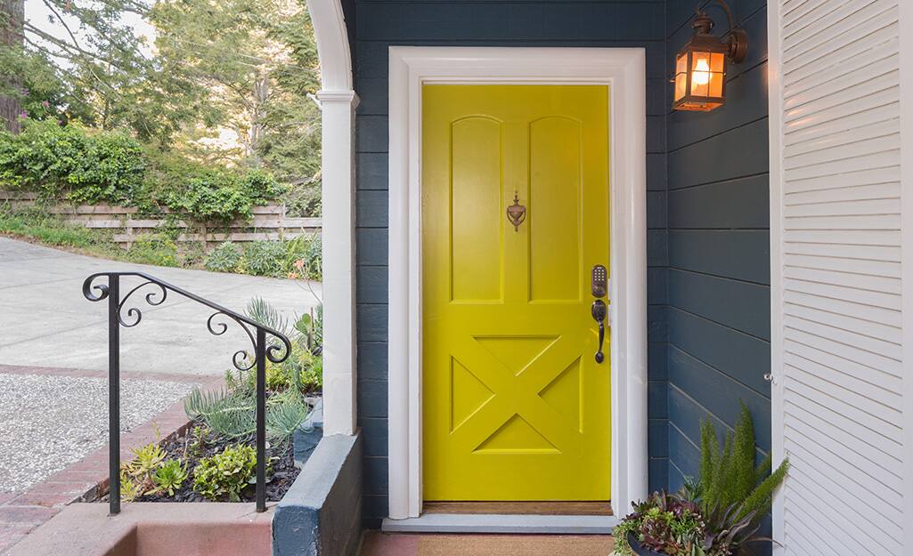 A front door painted yellow with a high-gloss finish. A front door painted yellow with a high-gloss finish.