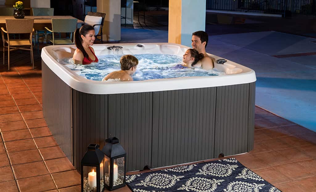 A family enjoying a hot tub on the patio. A family enjoying a hot tub on the patio.