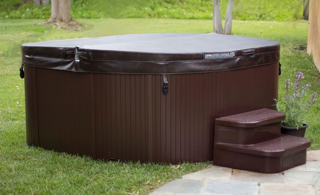 An outdoor hot tub covered with a protective top. An outdoor hot tub covered with a protective top.