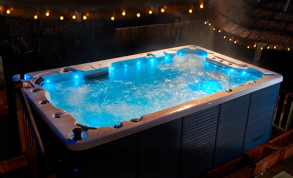 A rectangular swim spa with blue LED lights. A rectangular swim spa with blue LED lights.