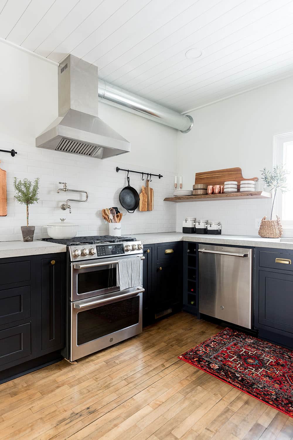 The corner of a kitchen with GE Cafe stainless steel appliances. The corner of a kitchen with GE Cafe stainless steel appliances.
