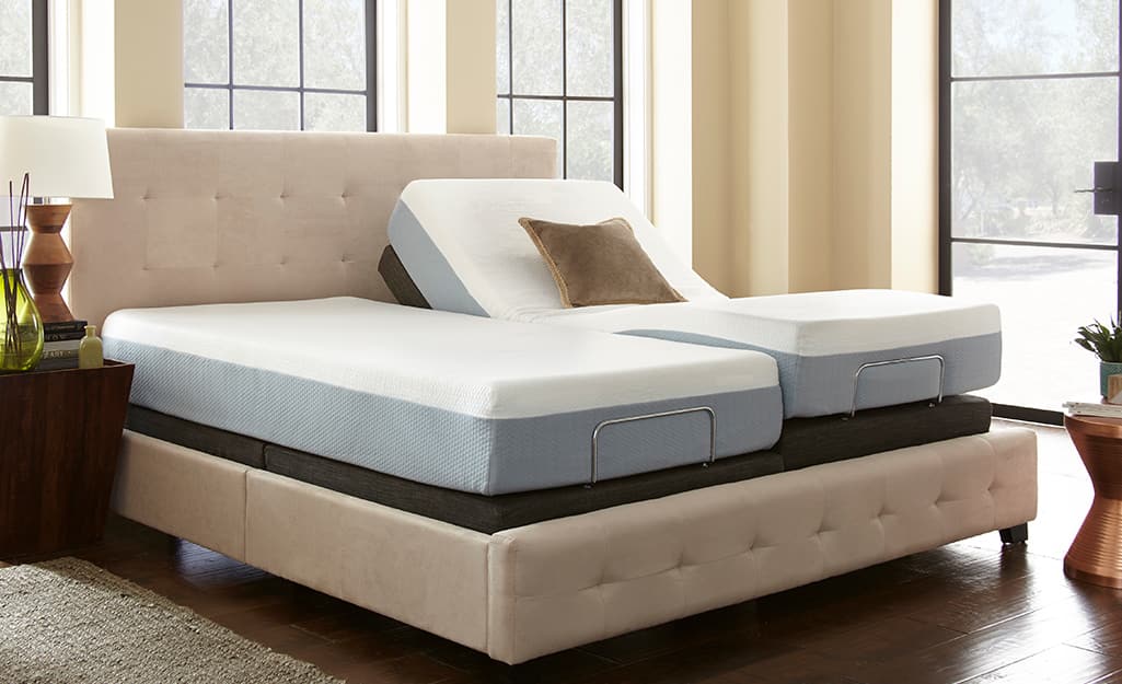 A bed with two mattresses on adjustable risers. A bed with two mattresses on adjustable risers.