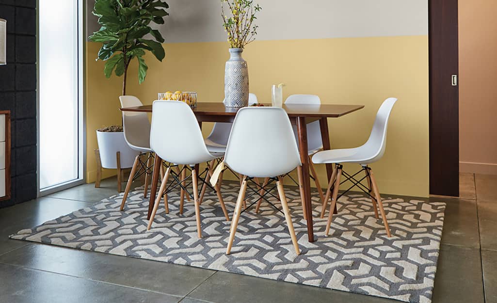 A table and chairs stand on a stained concrete floor. A table and chairs stand on a stained concrete floor.