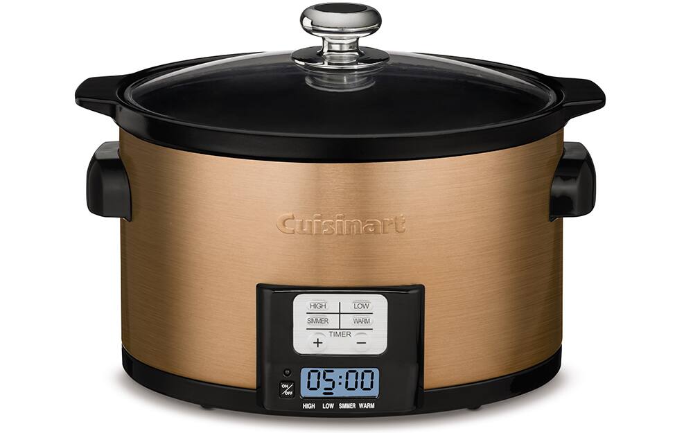 A gold slow cooker on a white background. A gold slow cooker on a white background.