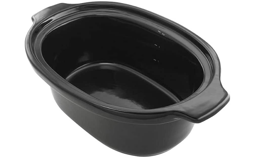 A black ceramic slower cooker insert on a white background. A black ceramic slower cooker insert on a white background.