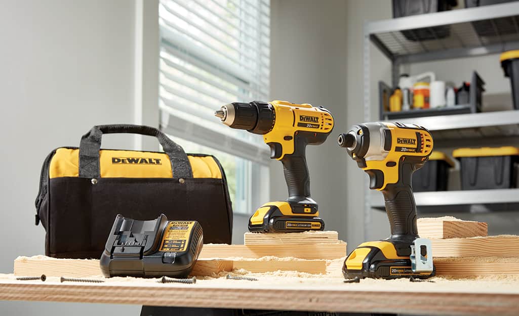 A set of drills sit on a workbench. A set of drills sit on a workbench.