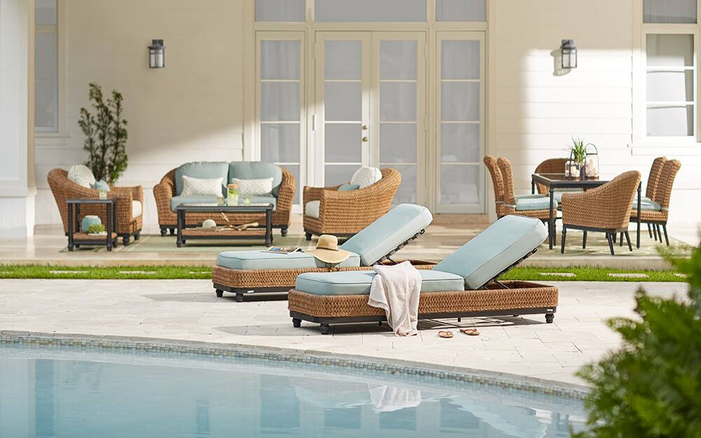 A backyard pool area with wall lights in the background A backyard pool area with wall lights in the background