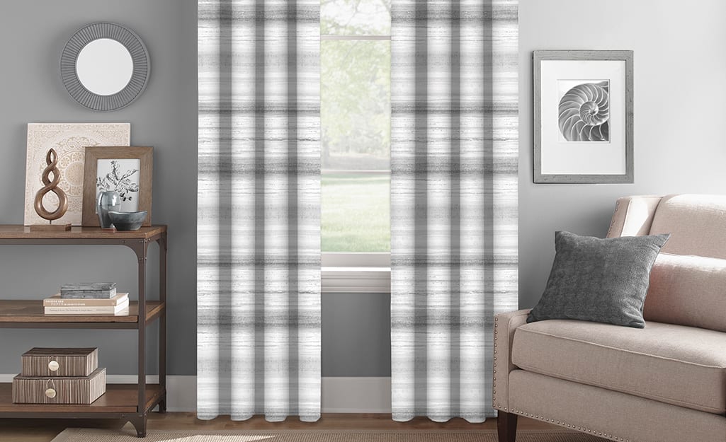 Striped gray and white curtains in a living room. Striped gray and white curtains in a living room.