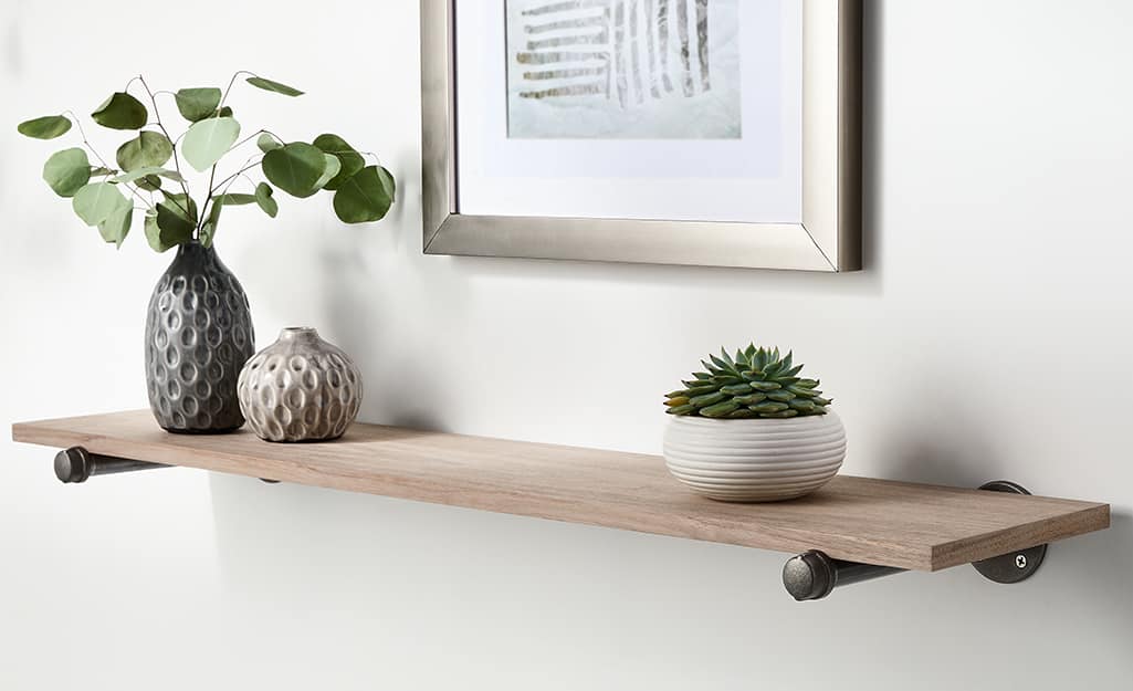 A shelf and photo attached to a wall with wall anchors. A shelf and photo attached to a wall with wall anchors.
