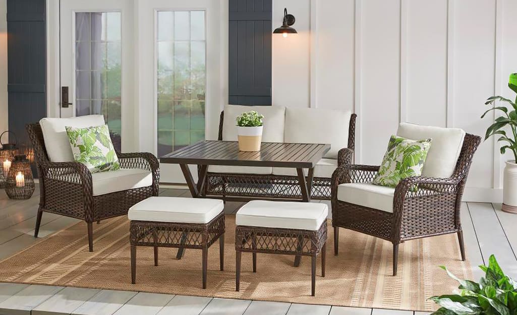 A Hampton Bay patio set in brown wicker with white cushions. A Hampton Bay patio set in brown wicker with white cushions.