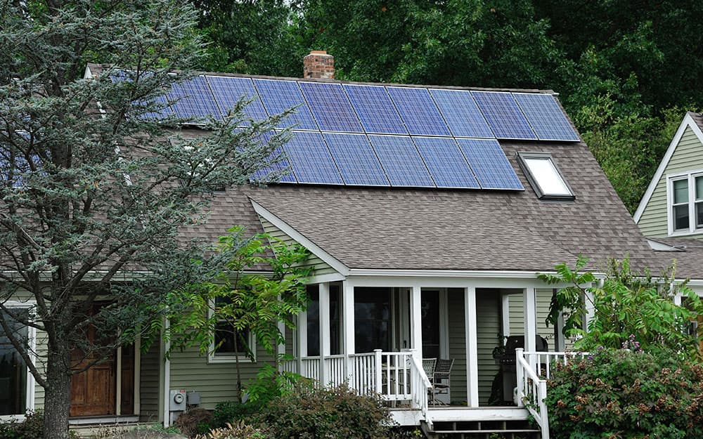 A house with solar panels installed on the roof. A house with solar panels installed on the roof.
