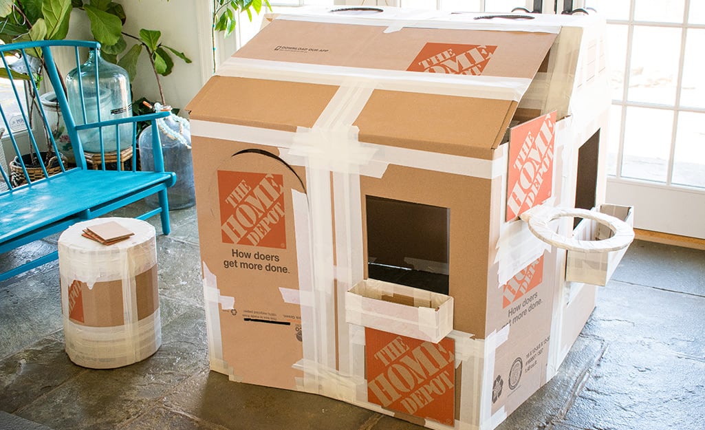 An assembled deluxe cardboard playhouse before decoration. An assembled deluxe cardboard playhouse before decoration.