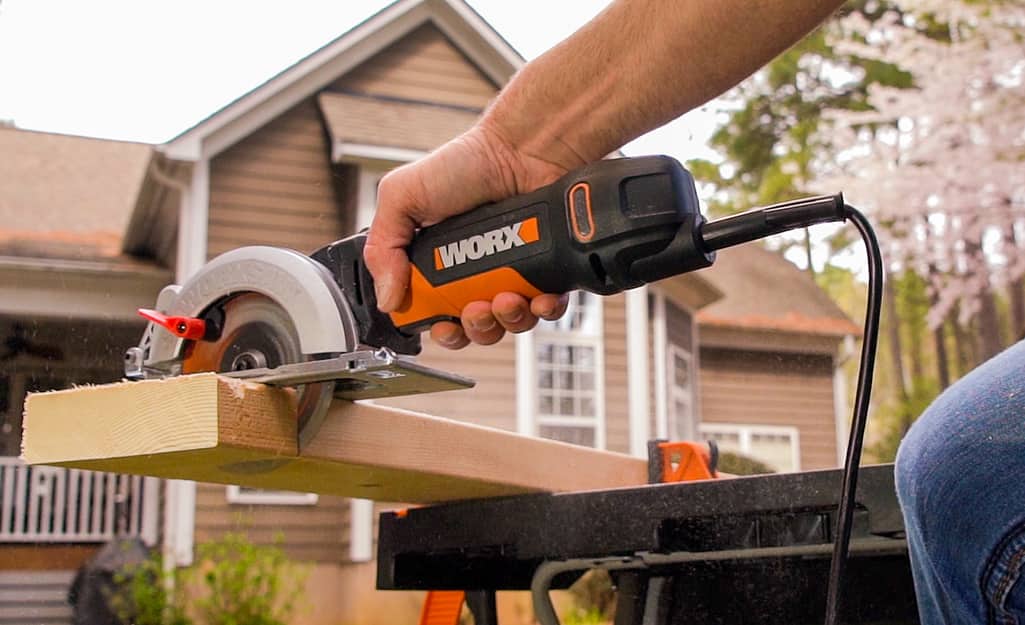 Someone cutting a wood board. Someone cutting a wood board.