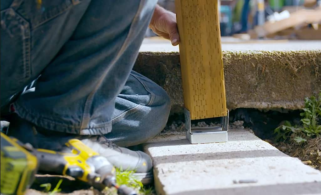 A beam being attached to form a deck. A beam being attached to form a deck.