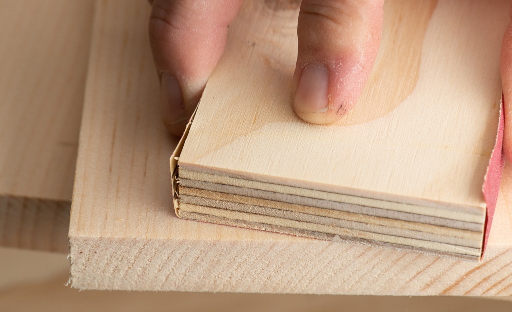 A person examining the quality of lumber. A person examining the quality of lumber.