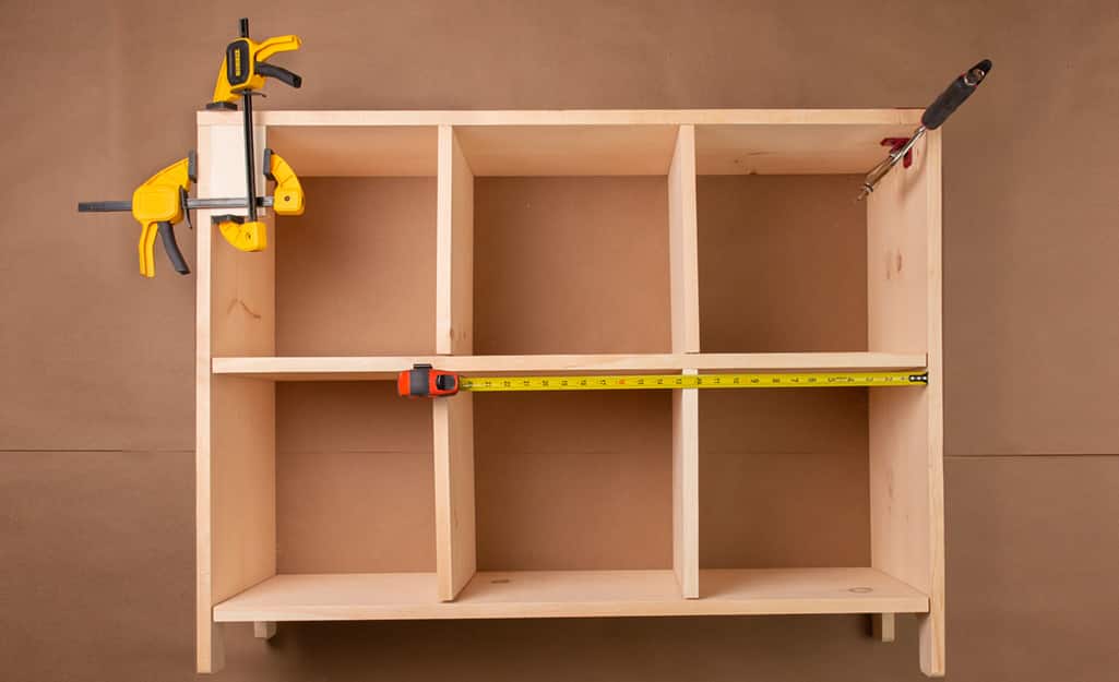 A cubby storage clamped together to dry fit the boards. A cubby storage clamped together to dry fit the boards.