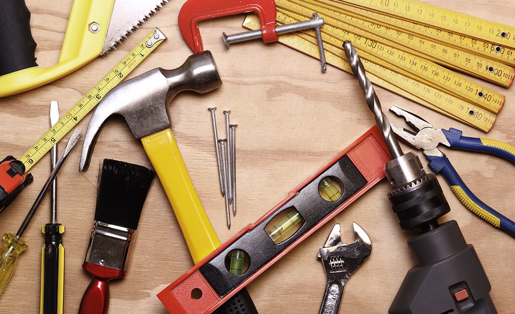 Collection of tools lying on top of a wood surface. Collection of tools lying on top of a wood surface.