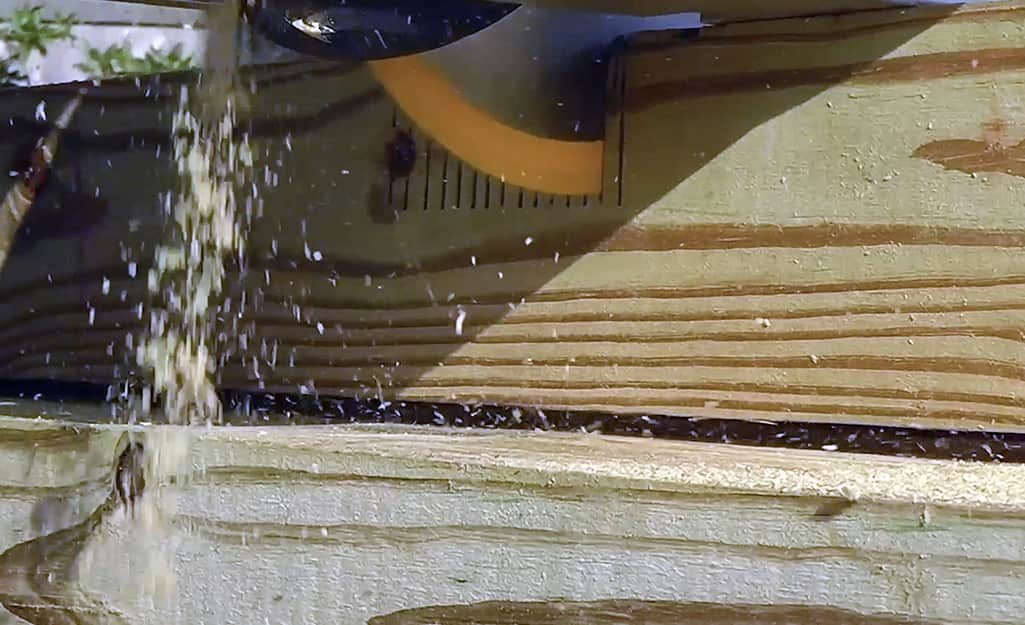 A circular saw cutting notches in a fence post. A circular saw cutting notches in a fence post.