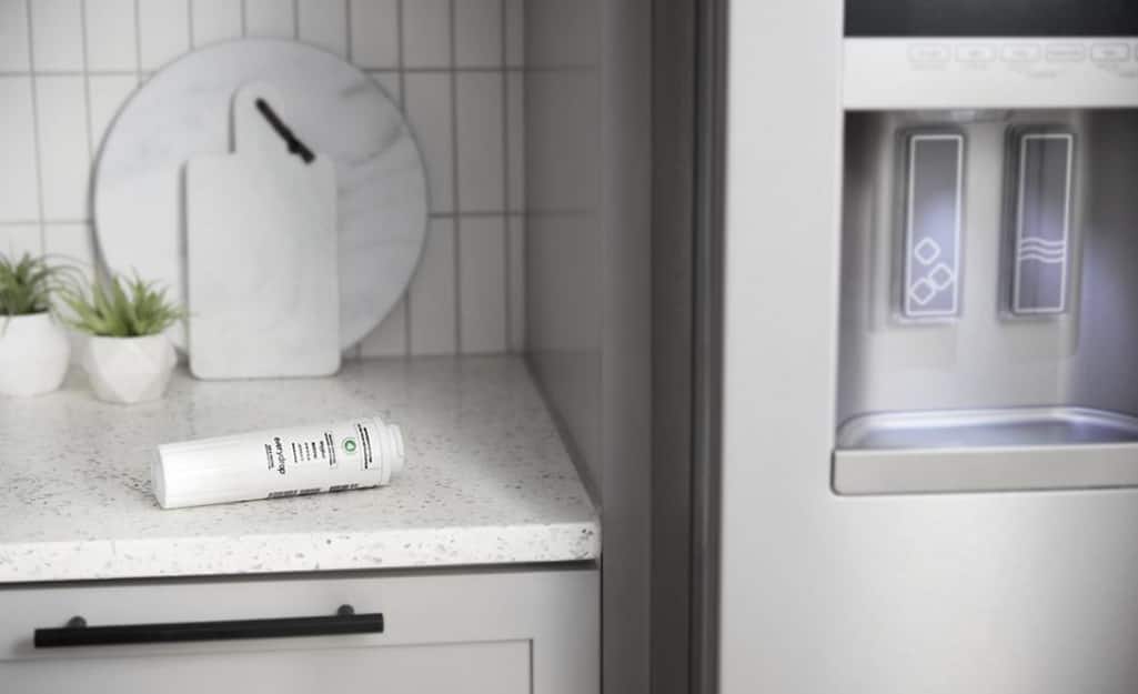 A refrigerator filter sitting on a counter. A refrigerator filter sitting on a counter.
