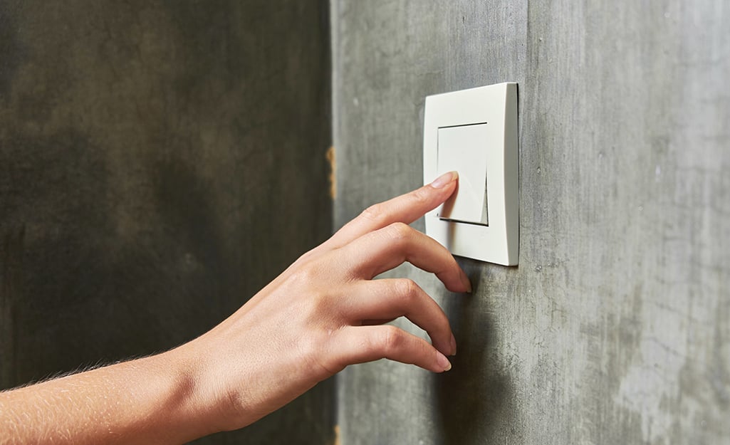 A person turning off a light switch. A person turning off a light switch.