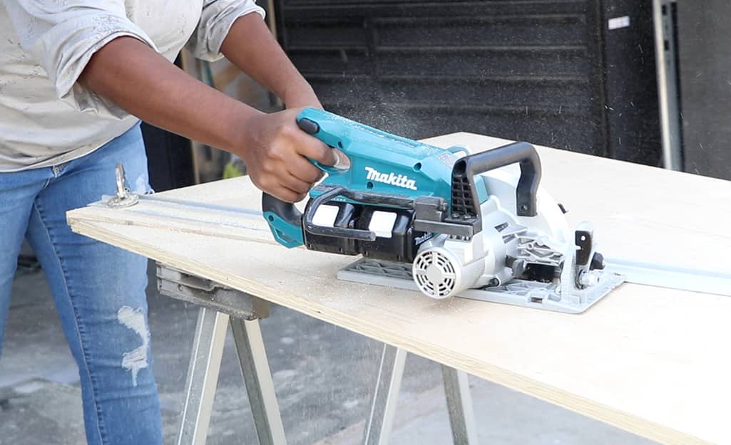 A person uses a saw to create diagonal trims for a door. A person uses a saw to create diagonal trims for a door.