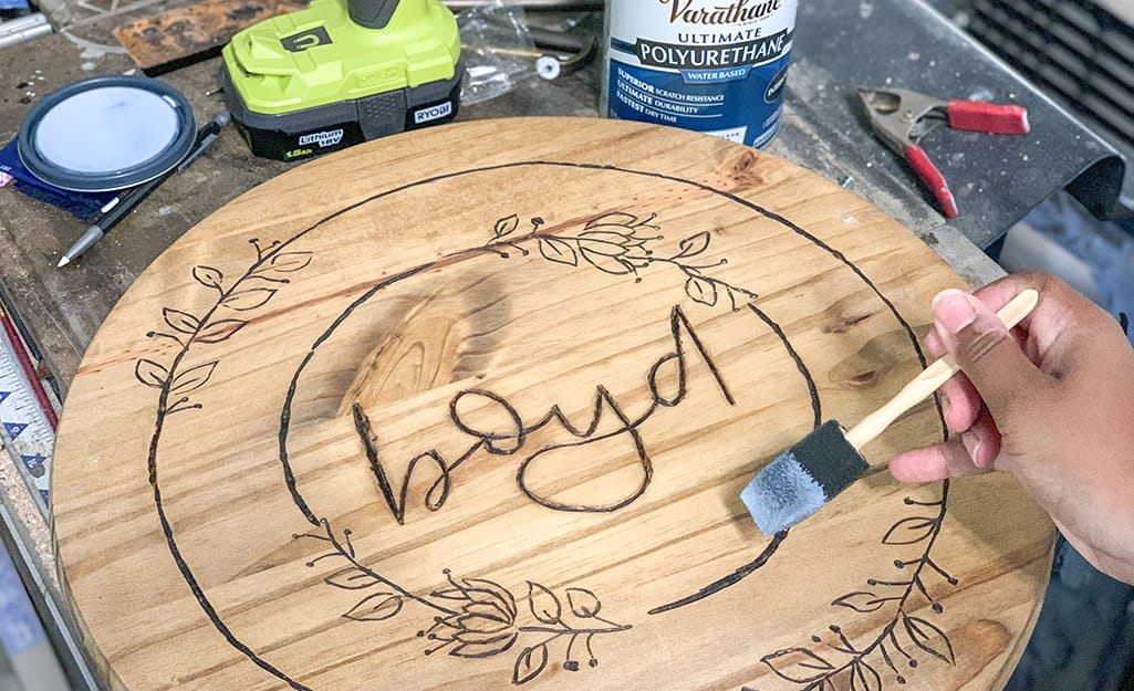 A wood round is painted with sealant. A wood round is painted with sealant.