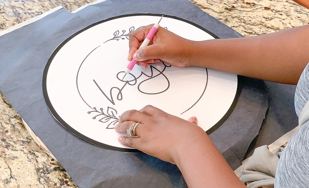 A stylus is used to trace the image onto carbon paper. A stylus is used to trace the image onto carbon paper.