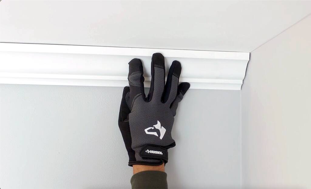 The butt joint of the moulding should fit flush against the wall. The butt joint of the moulding should fit flush against the wall.