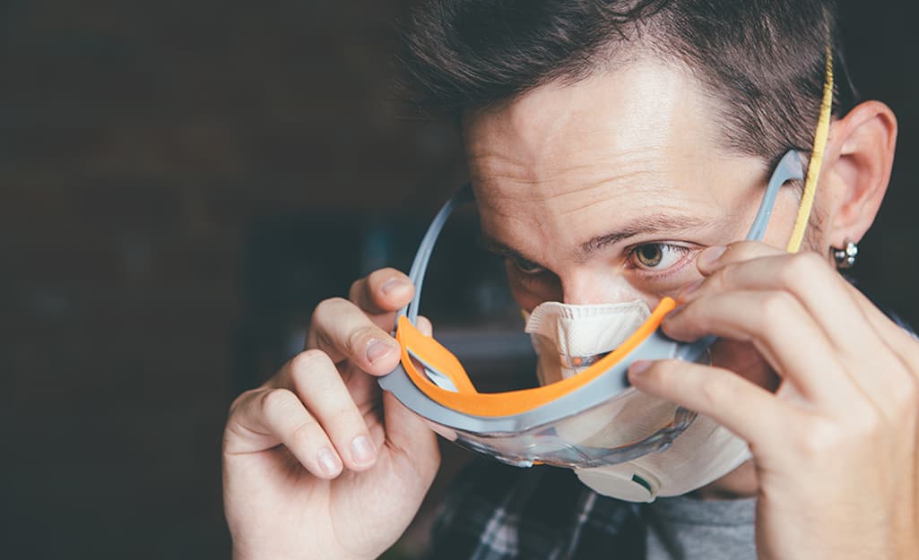 A man putting on safety glasses. A man putting on safety glasses.