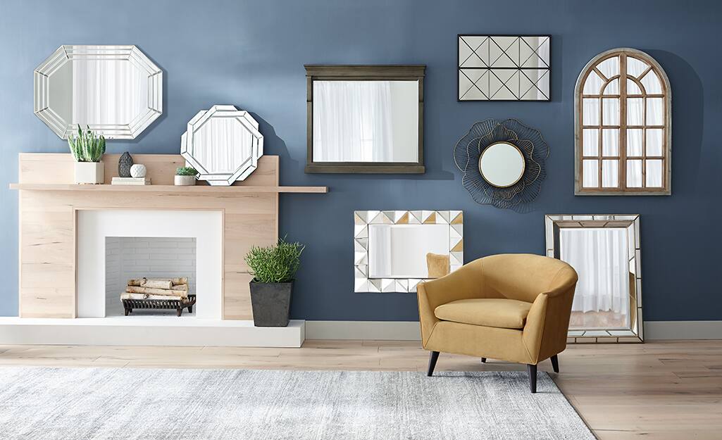 A variety of mirrors in different shapes and sizes decorating a gallery wall.