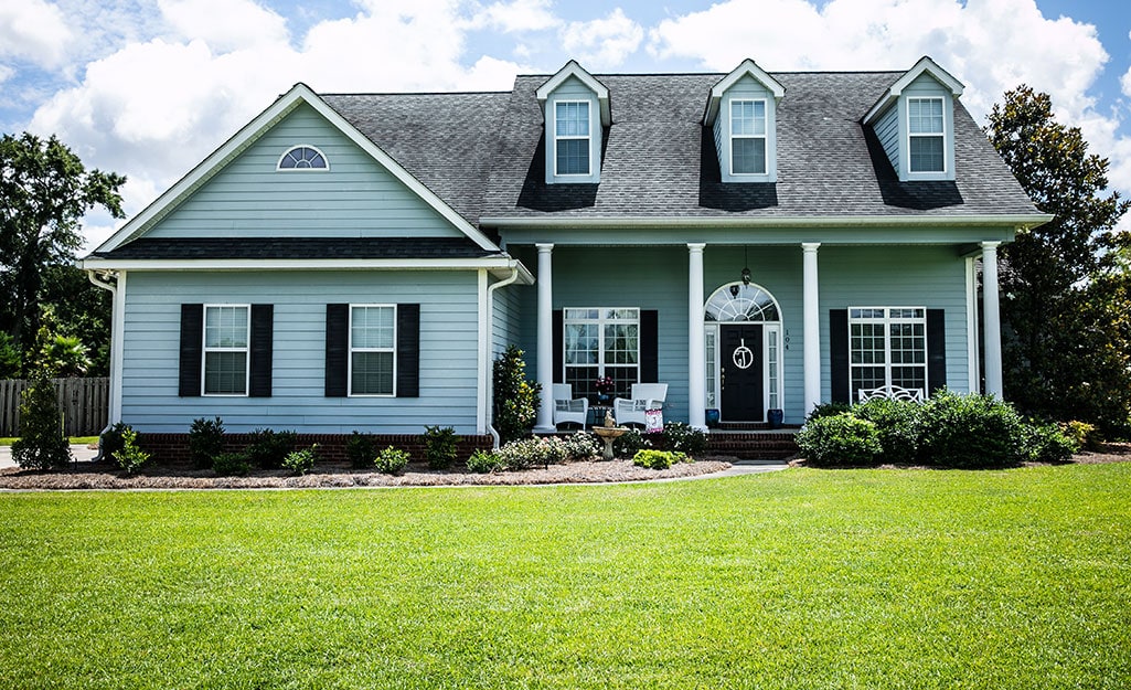 A home with a lush green front lawn. A home with a lush green front lawn.