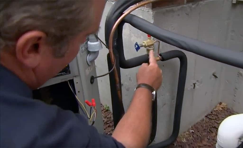 A man pointing to the fittings on a pipe A man pointing to the fittings on a pipe