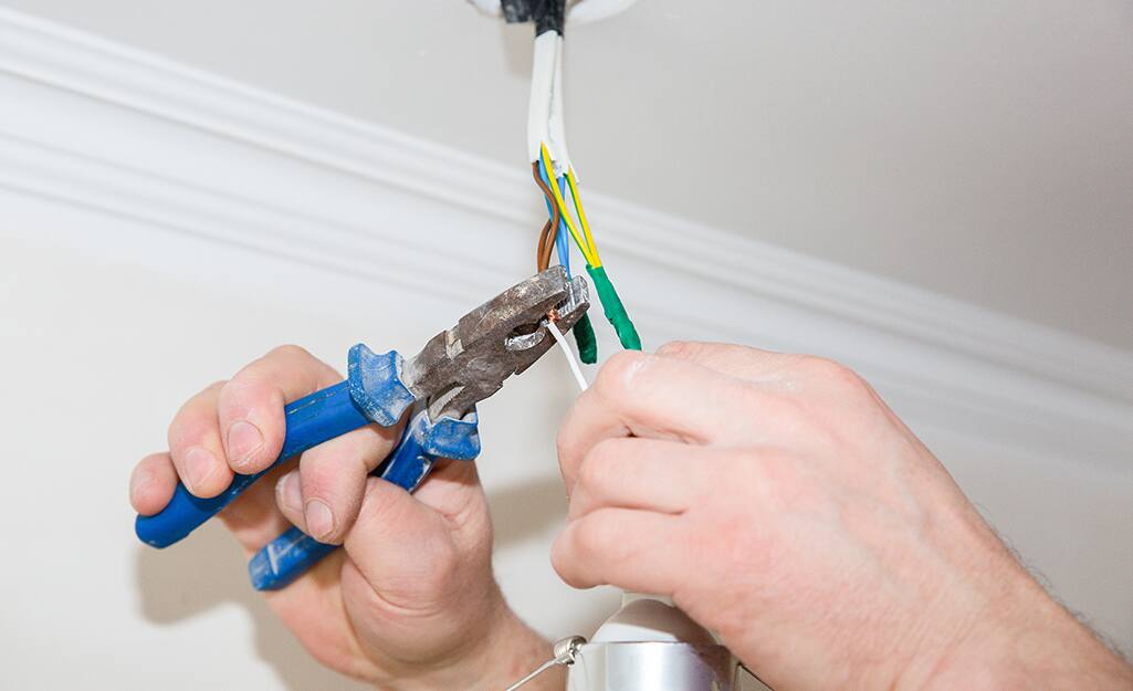 Someone stripping electrical wire. Someone stripping electrical wire.