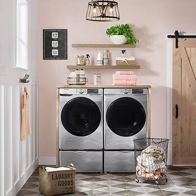 Front load washer and dryer side by side in a laundry room.