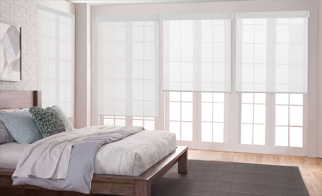Sheer shades on windows in a bedroom. Sheer shades on windows in a bedroom.