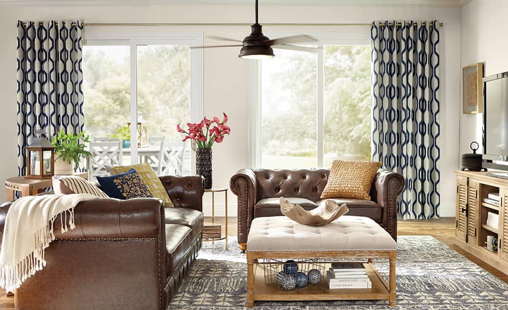 Drapery panels hanging above a window in a living space. Drapery panels hanging above a window in a living space.
